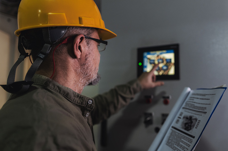 contractor setting up a programmable thermostat.