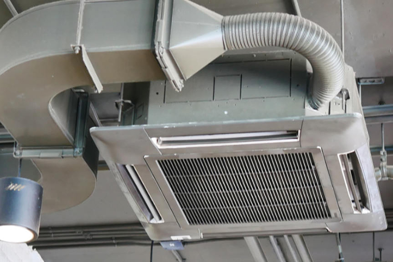 5 Tips to Help You Lower Your Energy Bills for Your Business This Fall. Photo of Air conditioner vents installed in ceiling of a commercial building.