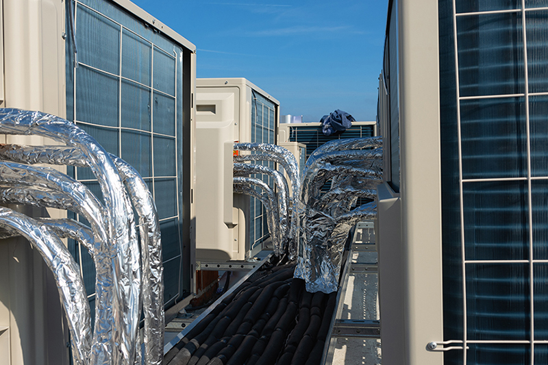 Repairing Your Rooftop Unit. Photo of multiple rooftop units installed on a roof.